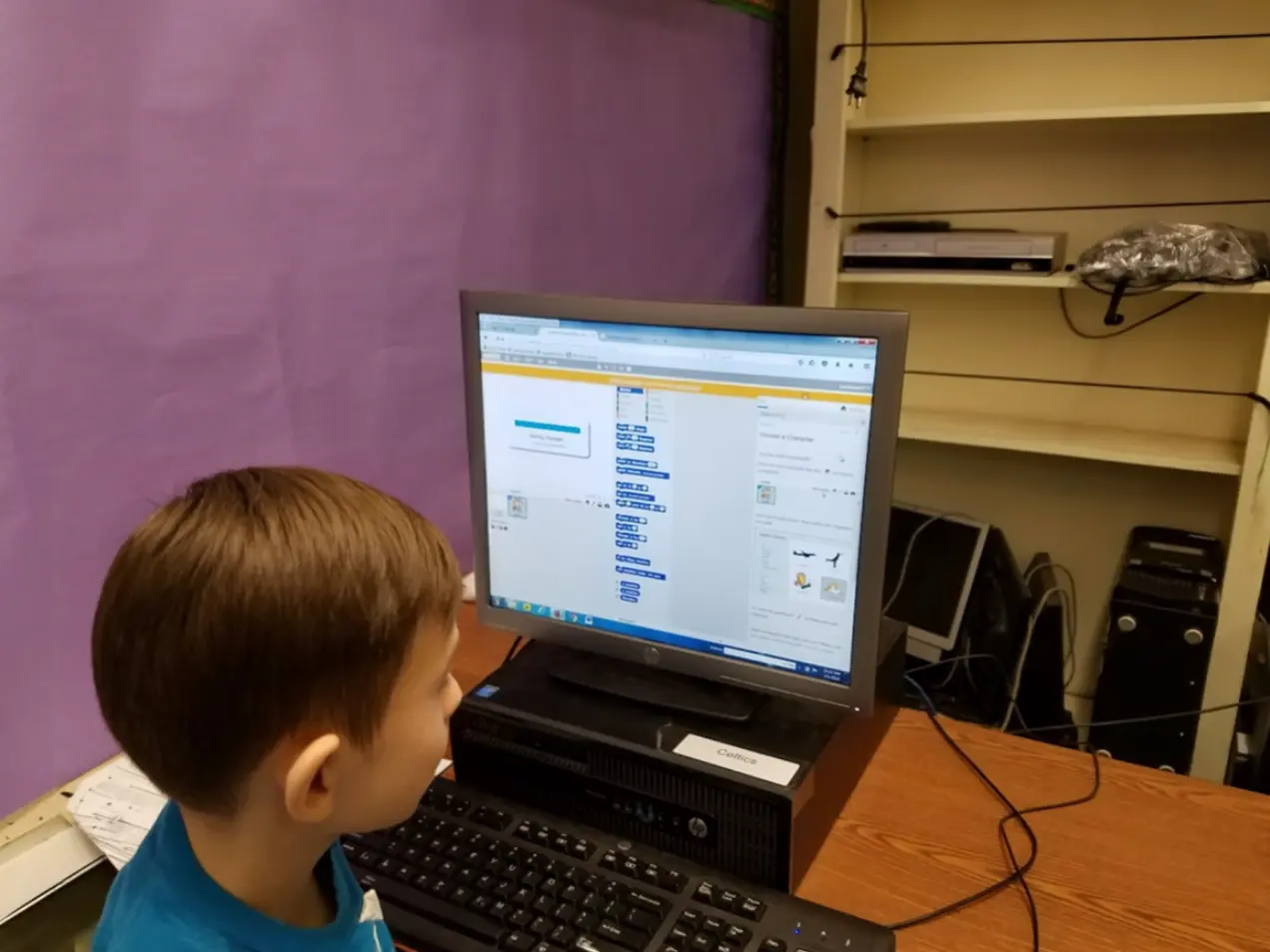 Student using Blockly visual coding software